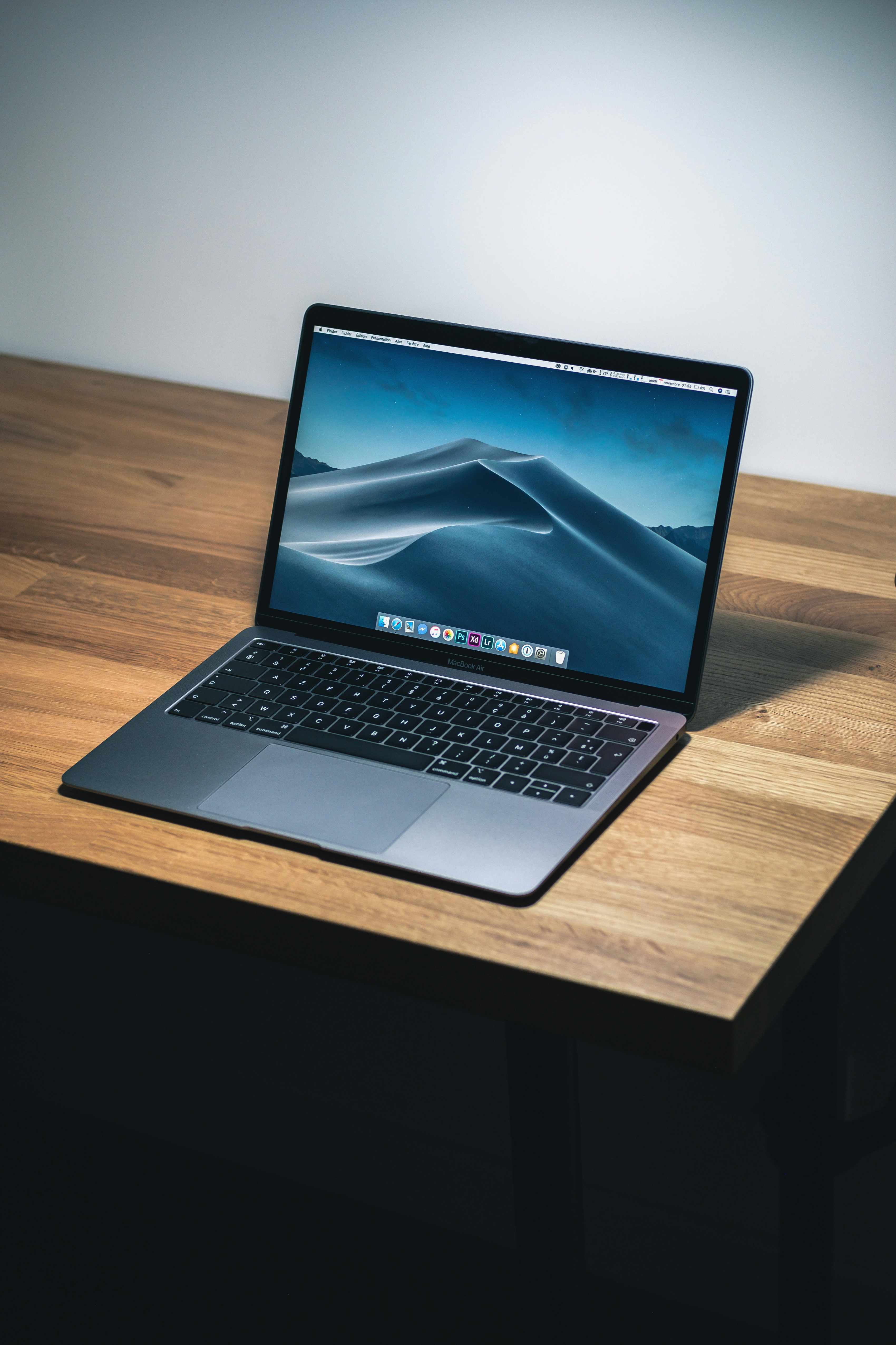 MacBook laptop showing website builder interface for no-code website creation - Photo by Howard Bouchevereau on Unsplash
